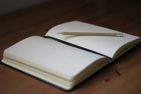 Open journal with pencil on top
